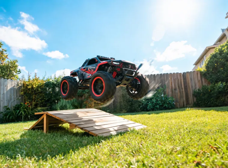 Arrma electric toy car jumping on a backyard ramp